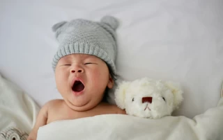 Sleepy baby with teddy bear
