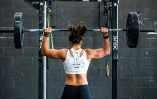Women exercising with barbell